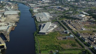 AX110_150E - 5.5K aerial stock footage of orbiting riverfront shopping center in Glasgow, Scotland