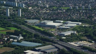 AX110_152 - 5.5K aerial stock footage of M8 Freeway near warehouse buildings, Glasgow, Scotland