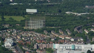 AX110_153 - 5.5K aerial stock footage of residential neighborhood and metal structures, Glasgow, Scotland