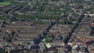 AX110_175 - 5.5K aerial stock footage of rows of apartment buildings, Glasgow, Scotland