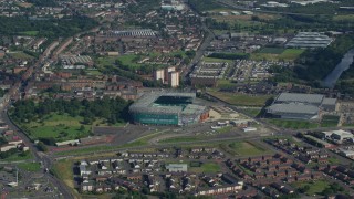 AX110_185E - 5.5K aerial stock footage approach Celtic Park soccer stadium in Glasgow, Scotland