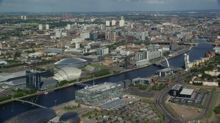 AX110_206E - 5.5K aerial stock footage approach office buildings from River Clyde, Glasgow, Scotland