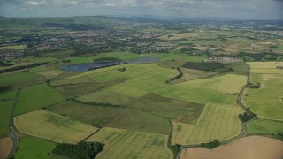 5.5K aerial stock footage approach farming fields and rural neighborhoods outside of Glasgow, Scotland Aerial Stock Footage | AX110_219E