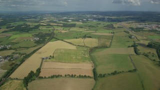 AX110_224E - 5.5K aerial stock footage of fields and farms on the outskirts of Glasgow, Scotland