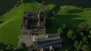 5.5K aerial stock footage tilt to bird's eye of Linlithgow Palace and St. Michael's Parish Church, Scotland Aerial Stock Footage | AX111_023