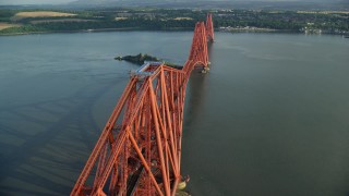 5.5K aerial stock footage of tracking a commuter train on Forth Bridge over Firth of Forth, Scotland Aerial Stock Footage | AX111_076E