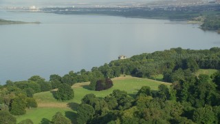 AX111_085E - 5.5K aerial stock footage of historic Barnbougle Castle and Dalmeny House by Firth of Forth, Edinburgh, Scotland