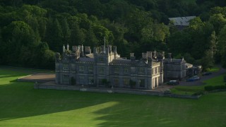 AX111_090 - 5.5K aerial stock footage of Dalmeny House beside trees, Edinburgh, Scotland