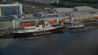 AX111_121E - 5.5K aerial stock footage of HMY Britannia at the Port of Edinburgh, Scotland