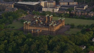 AX112_009 - 5.5K aerial stock footage of orbiting a castle and trees, Edinburgh, Scotland at sunset