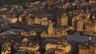 5.5K aerial stock footage of flying by Balmoral Hotel and North Bridge, Edinburgh, Scotland at sunset Aerial Stock Footage | AX112_057E