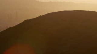 AX112_070E - 5.5K aerial stock footage of Edinburgh Castle seen from Arthur's Seat, Scotland at sunset