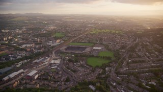 AX112_109E - 5.5K aerial stock footage of flying by Murrayfield Stadium, Edinburgh, Scotland at sunset