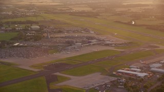 5.5K aerial stock footage of terminals and control tower of Edinburgh Airport, Scotland at sunset Aerial Stock Footage | AX112_116E