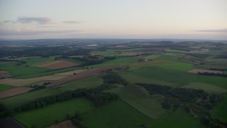 5.5K aerial stock footage of green farm fields, Broxburn, Scotland at sunset Aerial Stock Footage | AX112_130