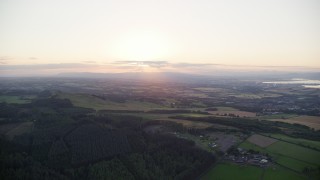 5.5K aerial stock footage of sun setting over farmland, Linlithgow, Scotland Aerial Stock Footage | AX112_135E