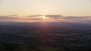 5.5K aerial stock footage of the setting sun over farmland in Linlithgow, Scotland Aerial Stock Footage | AX112_137