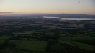 5.5K aerial stock footage of farmland near a power plant, Falkirk, Scotland at twilight Aerial Stock Footage | AX112_138