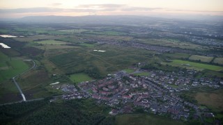 5.5K aerial stock footage of orbiting rural homes in small village near Falkirk, Scotland at twilight Aerial Stock Footage | AX112_146E