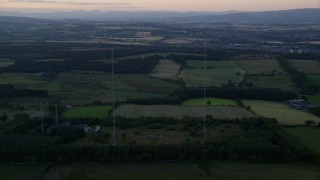 5.5K aerial stock footage orbit radio towers by farmland, Falkirk, Scotland at sunset Aerial Stock Footage | AX112_150