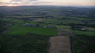 5.5K aerial stock footage of passing farms and fields in Bonnybridge, Scotland at twilight Aerial Stock Footage | AX112_155