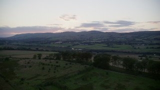 AX112_161 - 5.5K aerial stock footage of farmland in a rural landscape at twilight in Cumbernauld, Scotland