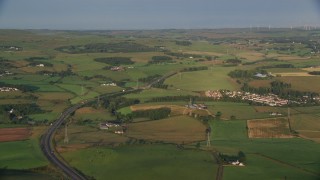 5.5K aerial stock footage of farms, fields and rural homes near A726 Highway, Glasgow, Scotland at sunrise Aerial Stock Footage | AX113_004E