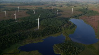 5.5K aerial stock footage fly over windmills and the Craigendunton Reservoir, Eaglesham, Scotland at sunrise Aerial Stock Footage | AX113_019E