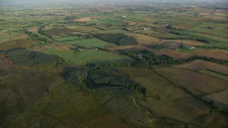 AX113_022E - 5.5K aerial stock footage of farms and farming fields, Kilmarnock, Scotland at sunrise