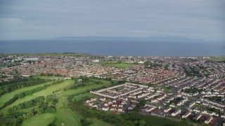 AX113_034E - 5.5K aerial stock footage of neighborhoods near Firth of Clyde, Prestwick, Scotland