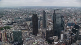 AX114_025E - 5.5K aerial stock footage orbiting Gherkin and Heron Tower, reveal The Shard in London, England