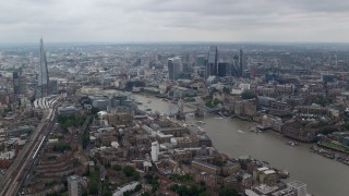 5.5K aerial stock footage of Tower Bridge and Tower of London near skyscrapers in Central London, England Aerial Stock Footage | AX114_056E