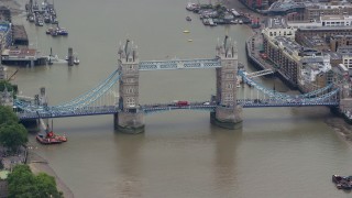 AX114_083E - 5.5K aerial stock footage of orbiting Tower Bridge spanning River Thames, London, England