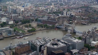 5.5K aerial stock footage of passing the Tower of London and Tower Bridge over the River Thames, England Aerial Stock Footage | AX114_119E