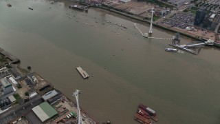 5.5K aerial stock footage of orbit Emirates Air Line gondolas and reveal The O2 arena, London, England Aerial Stock Footage | AX114_142E