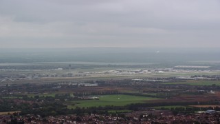 5.5K aerial stock footage of flying by London Heathrow Airport, England Aerial Stock Footage | AX114_284E