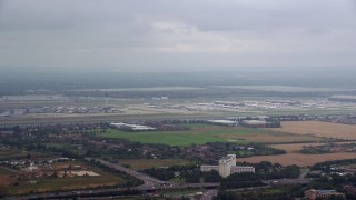 5.5K aerial stock footage track commercial jet taking off from London Heathrow Airport, England Aerial Stock Footage | AX114_288E