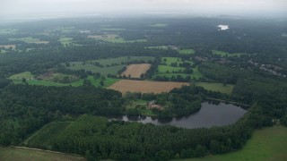 AX114_340E - 5.5K aerial stock footage of orbiting an upscale home among farmland, Ascot, England