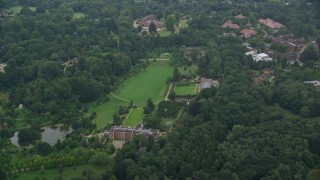 5.5K aerial stock footage of an orbit of upscale homes surrounded by trees, Ascot, England Aerial Stock Footage | AX114_342E