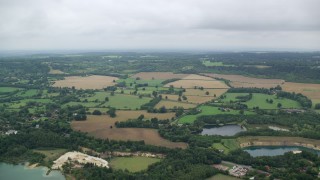 5.5K aerial stock footage of flying over farmland and homes, Redhill, England Aerial Stock Footage | AX114_383