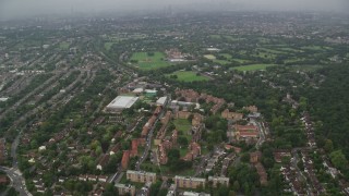 5.5K aerial stock footage of approaching Kingsdale School in rain, London, England Aerial Stock Footage | AX115_053