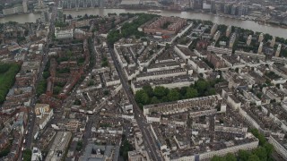 5.5K aerial stock footage of apartment buildings and city streets in the rain, London, England Aerial Stock Footage | AX115_081E