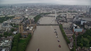 5.5K aerial stock footage of Westminster Bridge while following River Thames past Parliament, London, England Aerial Stock Footage | AX115_087E