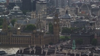 AX115_111E - 5.5K aerial stock footage of Big Ben and London Eye among city buildings, England