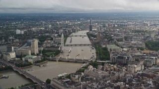 5.5K aerial stock footage approach bridges over the River Thames and London Eye, England Aerial Stock Footage | AX115_118E