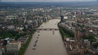 AX115_122E - 5.5K aerial stock footage of flying over bridges spanning the River Thames through London, England