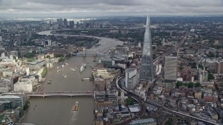 AX115_183E - 5.5K aerial stock footage pan from The Shard to London Bridge on River Thames, England