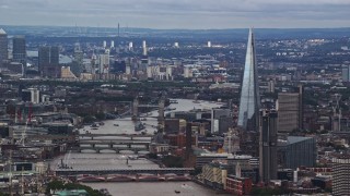 5.5K aerial stock footage of The Shard, and Tower Bridge spanning the Thames among cityscape, London, England Aerial Stock Footage | AX115_246E