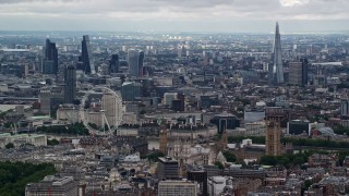 AX115_266E - 5.5K aerial stock footage of the London Eye with skyscrapers in the background, England