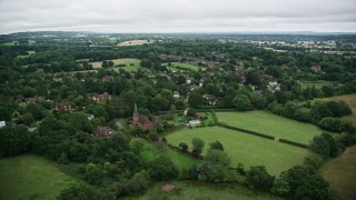 5.5K aerial stock footage orbiting homes in a rural village, Redhill, England Aerial Stock Footage | AX115_317E